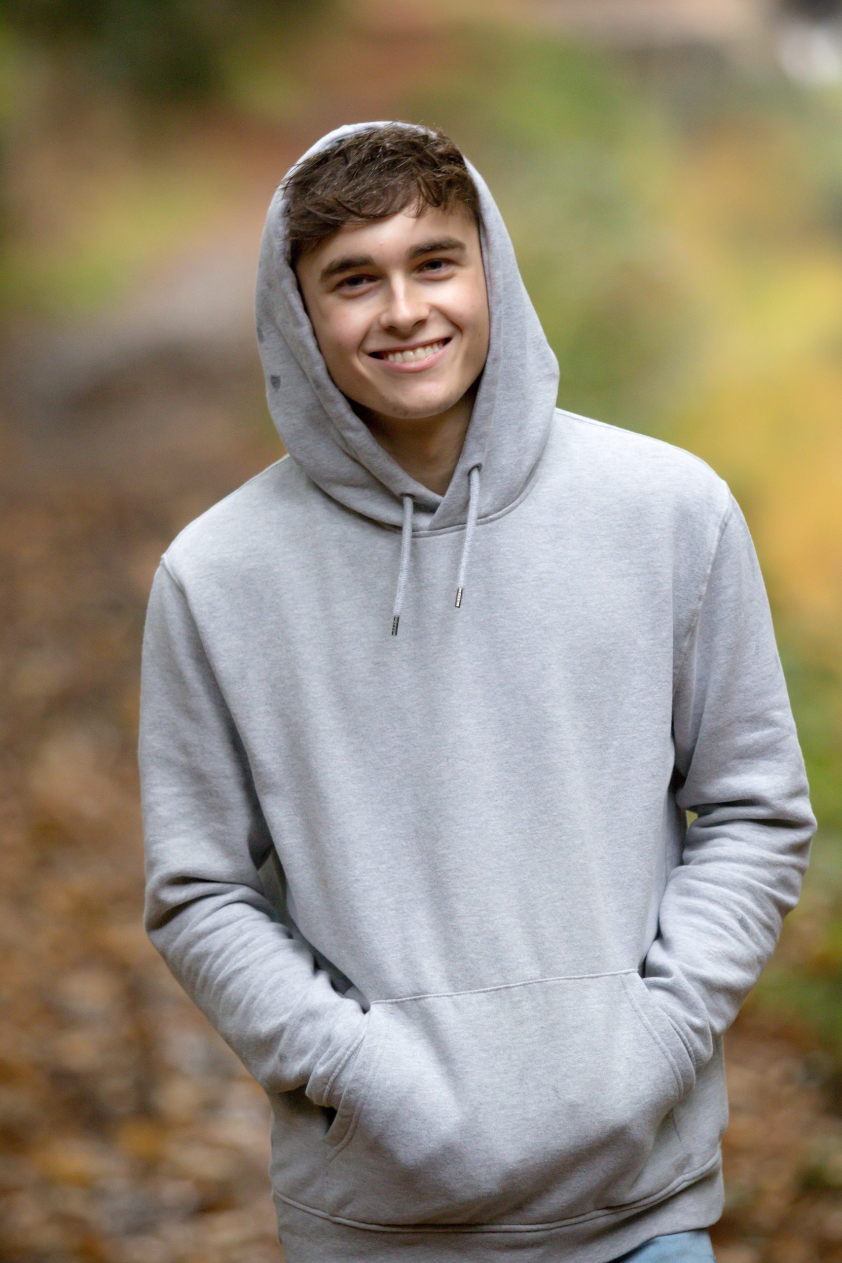 A teenage boy smiling for a picture.