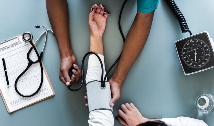 A woman having her blood pressure taken.