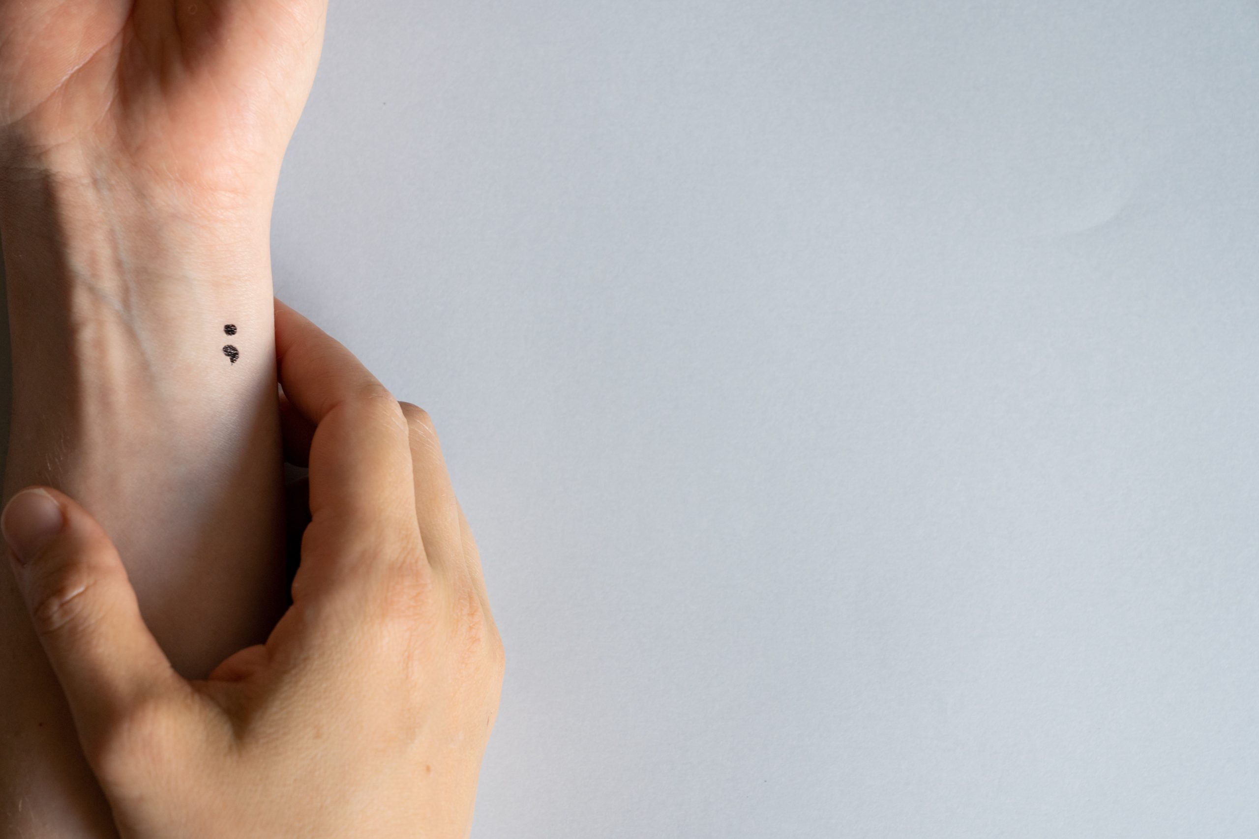 A semicolon tattoo has become a symbol for some individuals who deal with depression, anxiety, other mental health disorders, and suicidal ideation. It is a reminder of the choice to continue and a symbol against the stigma of mental health issues.