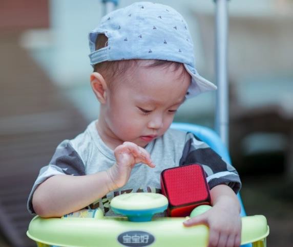 A male infant wearing stereotypically masculine clothing.