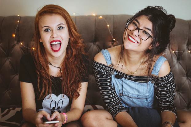 Two smiling teenage women