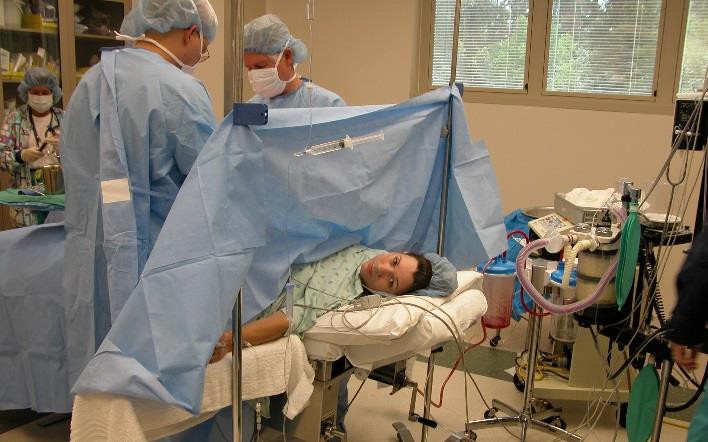 A woman receiving a C-section.